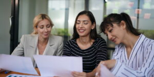 Businesswoman creating a presentation in office with a team