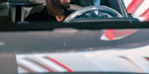 Young man looks out his car window