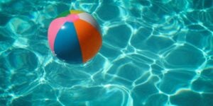 Colorful beach ball floating in a swimming pool